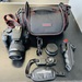 Canon EOS Rebel T100 DSLR Camera with 18-55 Lens, Charger, Bag & Accessories 